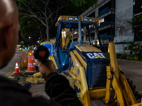 A KT Protection Services security specialist monitoring construction equipment at night