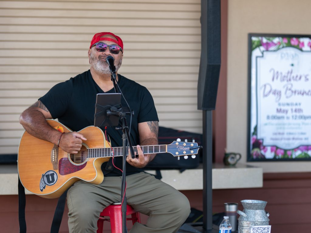 Entertainer playing guitar at an open air event in Hawaii